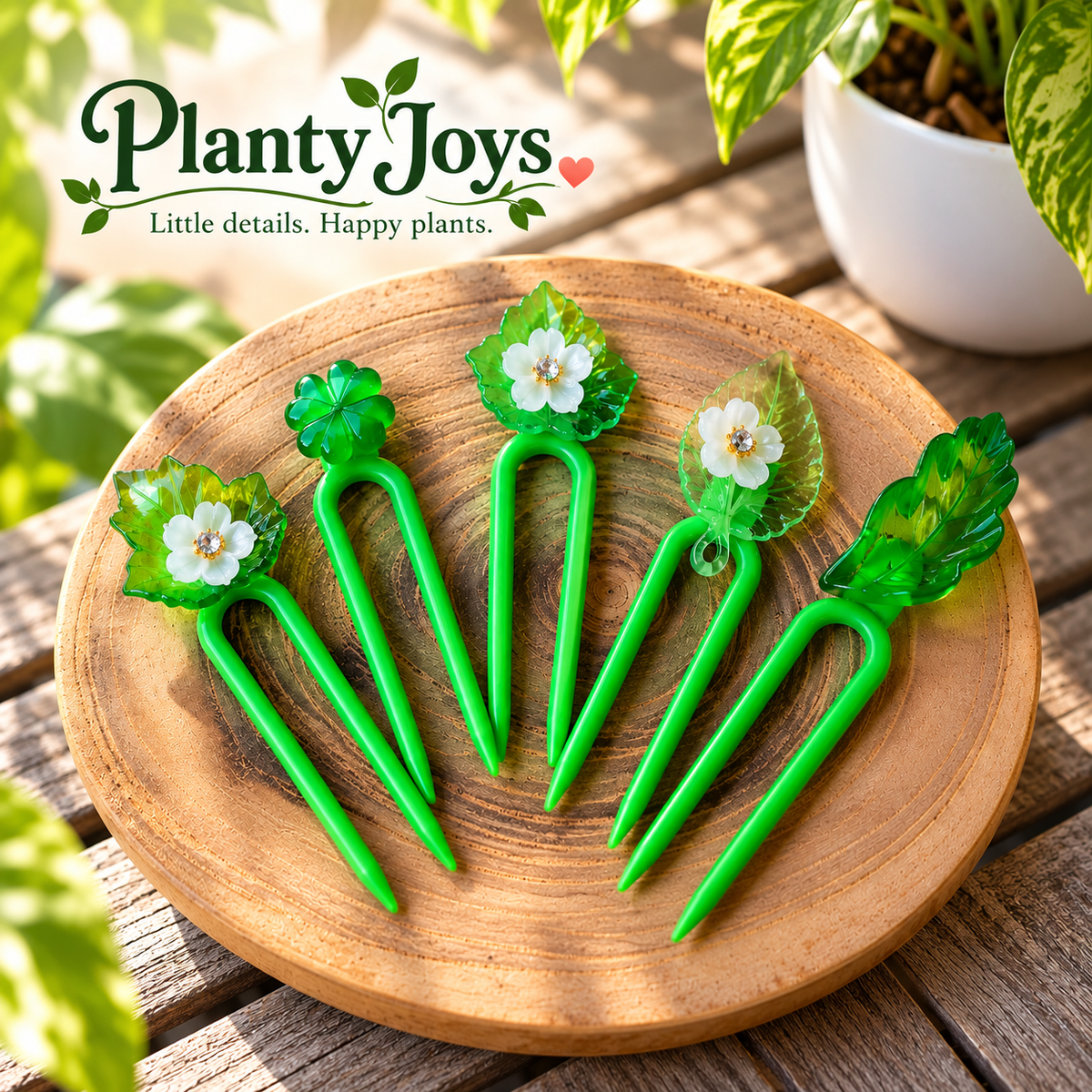 Planty Joys Botanical Series five-pack of green decorative plant stem supports featuring translucent leaves and delicate white flowers, displayed on a wooden tray.